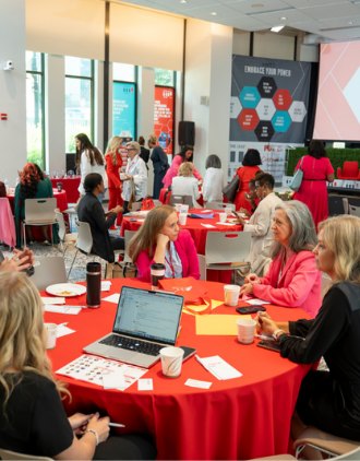 Attendees working together at a table during a past Power Up conference
